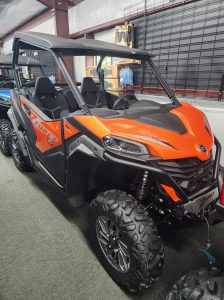 An orange 2023 ZForce 950 Trail side by side UTV in a showroom.
